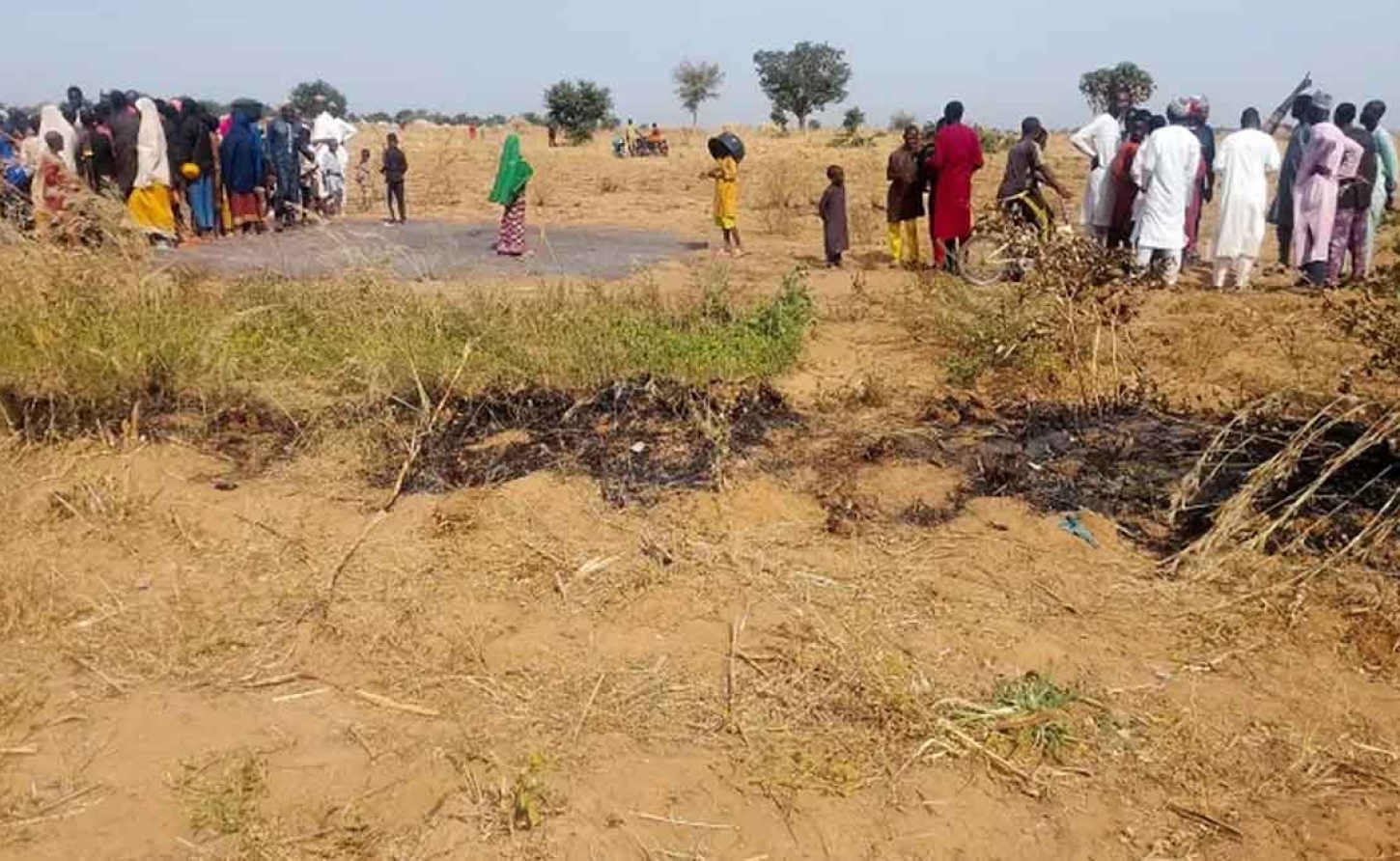 People gather at the site of the US air strike in Jabo Garin Maigari village in northern Nigeria [Reuters]
